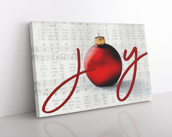 Joy to the World Christmas canvas with elegant script, ornament, and vintage sheet music background in a silver color.
