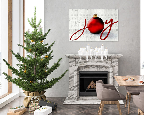 Joy to the World Christmas canvas with elegant script, ornament, and vintage sheet music background in a silver color on a wall
