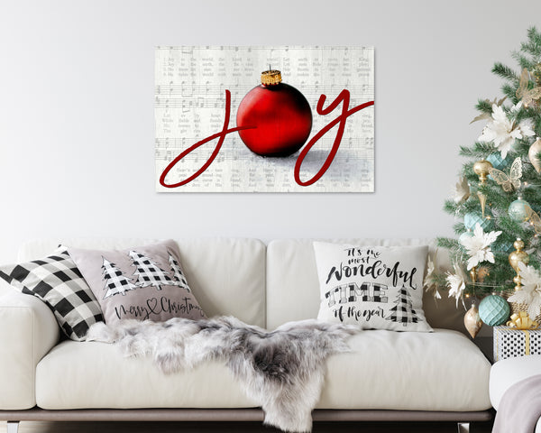 Joy to the World Christmas canvas with elegant script, ornament, and vintage sheet music background in a silver color.