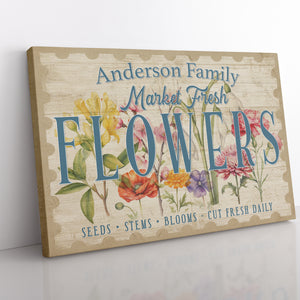 Close-up of custom flower market canvas showing detailed spring flower illustrations on a tan background. 