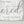 Detail of distressed wood texture and black lettering on light grey farmhouse sign