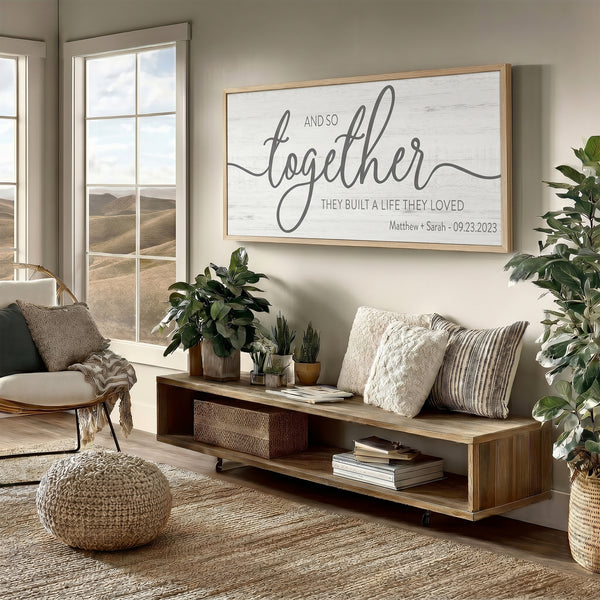 Living room with a wooden shelf, decorative pillows, and a large framed quote and so together they built the life they loved